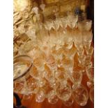 An extensive quantity of clear cut glassware to include three various decanters, six tall wines with