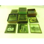Five small boxes of early photographic square glass plates depicting scenes of early 20th century