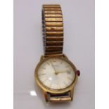 A gentleman's 9ct gold wristwatch, Garrard Automatic, the silvered dial with gilt baton numerals,