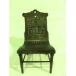 A miniature model chair with turned mahogany framework accommodating a studded Bentwood seat with