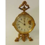 A 19th century gilded brass mantle clock, the circular case with lion mask mounts raised on shaped