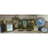 A mixed collection of small brass and other mantle clocks including reproduction lantern clock,