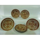 A set of eight 19th century oriental plates with painted decoration in brick red incorporating