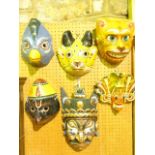 Four vintage eastern painted papier-mache masks with Zoomorphic details together with two further