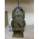 An old English style lantern clock of usual design striking on a single bell, the dial engraved