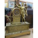 An early 19th century French mantle clock with cast and gilded brass case, classical motifs