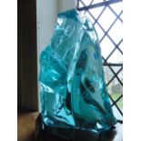 A large and heavy fragment of unshaped glass, coarsely of triangular form in a  pale blue colourway,