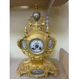 A 19th century gilded mantle clock, the shaped case with acanthus and other detail with porcelain