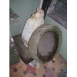 A weathered natural stone shallow trough/birdbath of circular form 64 cm diameter approximately,