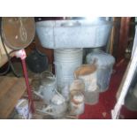 One lot of galvanised ware to include an oval tin bath, three watering cans of varying capacity,