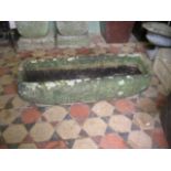 A weathered natural stone garden trough of rectangular form with rounded front corners, 105 cm