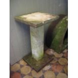 A weathered contemporary cast composition stone three sectional garden stand of square cut form