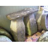 A matched pair of weathered natural stone staddle stone bases of inverted tapered form together with