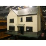 A dolls house with painted exterior, bay window, two chimney stacks, etc together with a quantity of