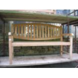 A good quality contemporary teak garden bench with slatted seat and oval vertical slatted back,