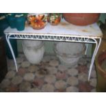 A painted steel garden/conservatory table of rectangular form with rounded corners, pierced frieze