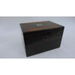A 19th century coromandel wood travelling box with rising lid and fitted interior with silver plated