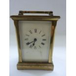 A 19th century brass carriage clock, the case with shaped pillars