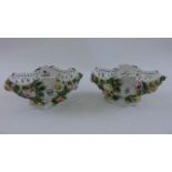 A pair of late 19th century continental porcelain baskets with shaped and pierced outline overlaid