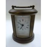 A small carriage clock by Matthew Norman, the oval case fitted with enamel dial and 8 day timepiece