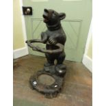 A Black Forest umbrella/stick stand in the form of a well modelled carved standing bear supporting