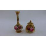 A Royal Worcester vase and cover with hand painted rosebud detail with pierced lid together with a