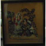 An early 19th century petit point panel showing a Turkish couple in a garden in Hogarth frame, 22