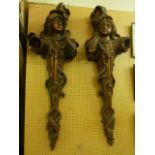 A pair of Art Nouveau carved timber wall mounts of organic form in the form of females, 105 cm max