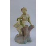 A Royal Worcester shot enamel, porcelain figure of a female sitting upon a tree stump, date marked
