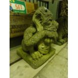 A good quality contemporary weathered cast composition stone gargoyle in the form of a beast with