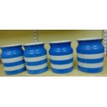 A set of four T G Green Cornishware blue and white banded storage jars, all 18 cm in height