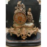 A Victorian spelter mantle clock in the romantic style, the drum movement with alabaster dial