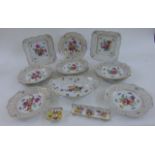 A collection of Dresden porcelains comprising twelve plates with hand painted floral detail within