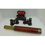 A three drawer brass and mahogany telescope together with two pairs of vintage pocket binoculars