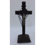 A 19th century tramp art crucifix set on a pyramid base, surmounted by a silver plated figure of