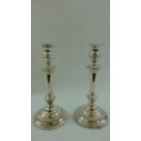 A pair of 19th century silver on copper candlesticks, the circular bases with gadroon borders, 28 cm