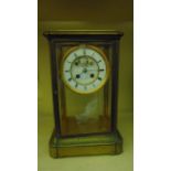 19th century brass framed four pane mantle clock with enamel dial and visible escapement and with