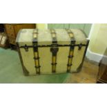 An early 20th century travelling trunk with domed lid, canvas covered with timber lathes and further