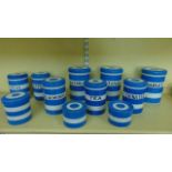 A collection of T G Green Cornish blue and white banded ware storage jars, all straight sided