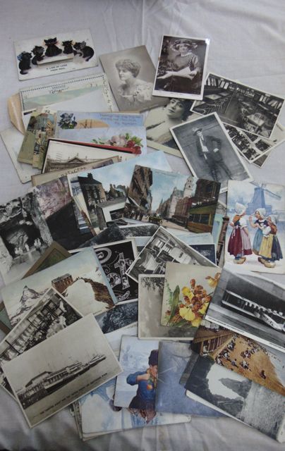 A basket containing several hundred unsorted postcards, British topographical, continental views,