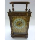 A late 19th century brass carriage clock, the case with reeded column supports and handle, the