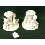 Pair Of Parion Ware Candlesticks In The Form Of Cherubs / Cupids 9.5h x 11 diam To bid live please