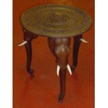 ORNATELY CARVED TABLE ON THREE INDIAN ELEPHANT HEAD AND TRUNK LEGS (h: 54.5 cm dia: 51 cm)