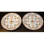 PAIR OF TIN GLAZED CIRCULAR PLATES PAINTED WITH RED AND BLUE FLORAL DECORATION, PROBABLY c18th (dia: