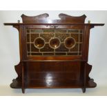 ARTS AND CRAFTS WALL CABINET WITH A CLOLOURED LEAD GLAZED PANELLED FALL DOOR WITH THREE ROUNDELLS