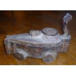 AN INDONESIAN CARVED WOOD SPICE CARRIAGE WITH A HINGED RISING AND SWIVELLING  TOP ON FOUR WHEELS (l: