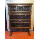 FLEMISH CARVED ELM AND BEECH THREE TIER SHELF UNIT WITH A CARVED FIGURE AND FLORAL PANELLED BACK AND