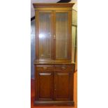 LATE VICTORIAN OAK CABINET WITH TWO GLAZED DOORS ABOVE TWO DRAWERS AND TWO PANELLED DOORS BELOW ON A