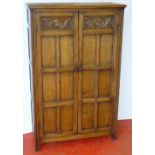 FLEMISH CARVED OAK/ELM WARDROBE WITH TWO PANELLED DOORS ON MOULDED RECTANGULAR SECTION FEET (174
