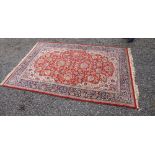 A BELGIAN KESHAN PATTERN RUG, THE MADDER FIELD WITH ALL OVER STYLISED FLORAL AND ANIMAL DECORATION